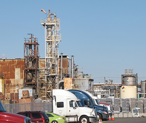 Industrial site with trucks parked in the foreground.