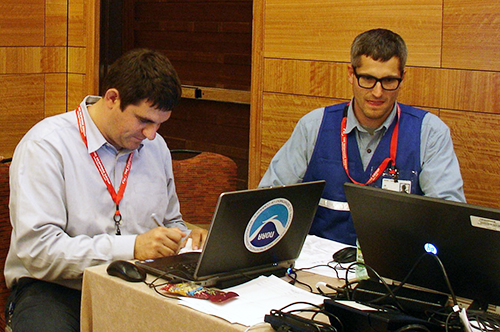 Two men working at computers.