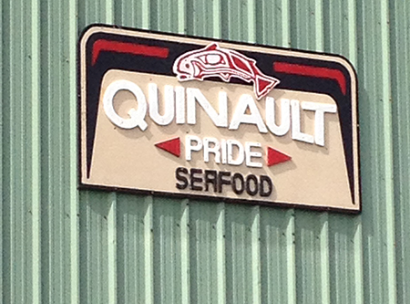 Outdoor sign advertising Quinault seafood. 
