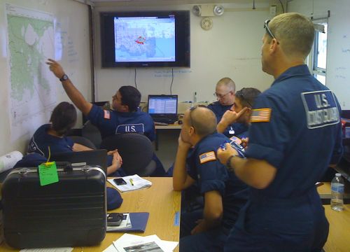 Men looking and pointing at a map.