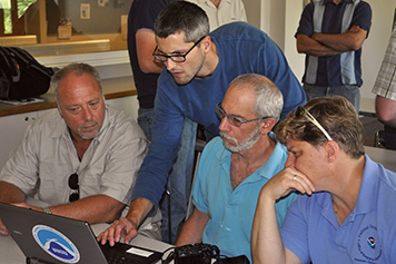 People working together at a computer.