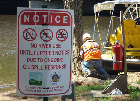 Posted sign closing river activity due to oil spill response.