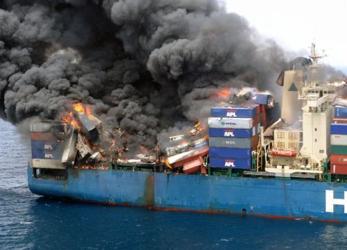 Fire and smoke on a container ship carrying hazardous materials at sea.