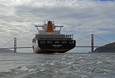 Cargo ship in San Francisco Bay with Bay Bridge.