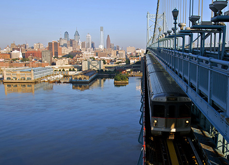 A train crossing over the Delaware River on the Benjamin Franklin Bridge.