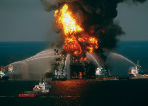 Deepwater Horizon oil rig on fire in Gulf of Mexico with firefighting boats.