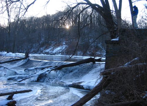 Creek passing over a dam in winter.