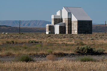 Cocooned F Reactor surrounded by grassland and hills at Hanford.