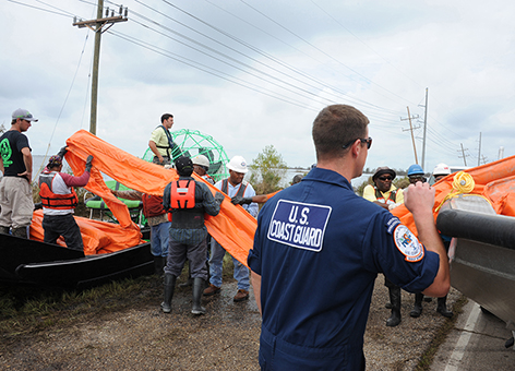 Coast Guard oversees loading of boom onto a response airboat in Lousiana.