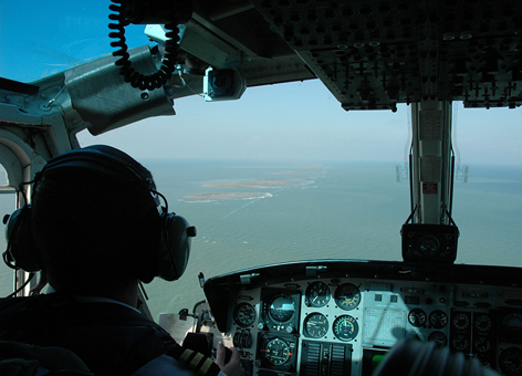 Pilot looking out airplane to Gulf of Mexico.