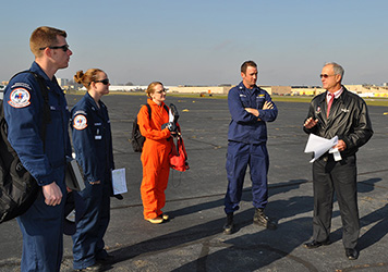 A pollution response team stands outside a helicopter.