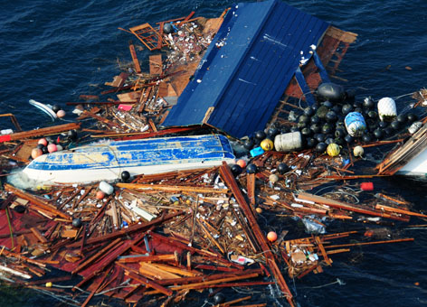Aerial view of scattered debris in the water.