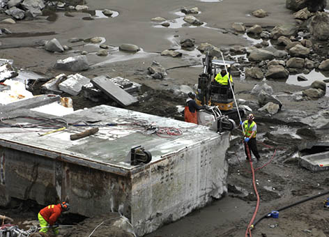 Workers dismantling the Japanese dock washed up on Washington's coast.