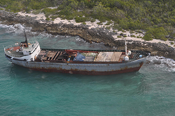 Ship stuck off the coast of a tropical island.