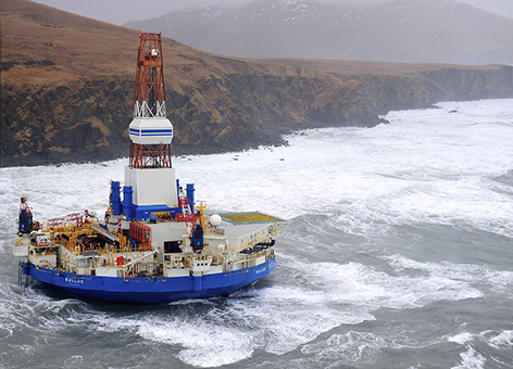 Rocky coast and habitats adjoin the grounded conical drilling unit Kulluk.