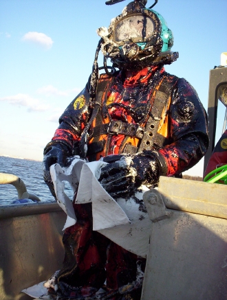 Diver covered in oil.