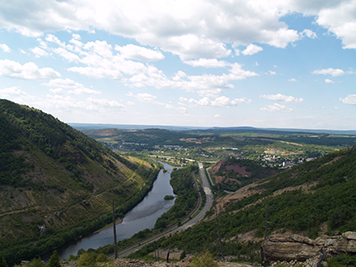 Lehigh River runs between a mountain and ridge with Palmerton in the background.