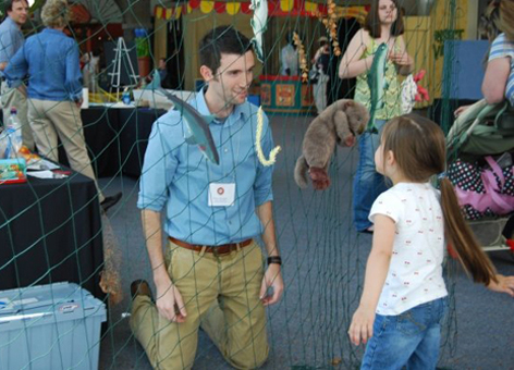 NOAA marine debris expert Peter Murphy teaches a child about trash in our ocean