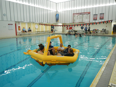 NOAA, with U.S. Coast Guard, practiced their ocean survival skills in a pool.