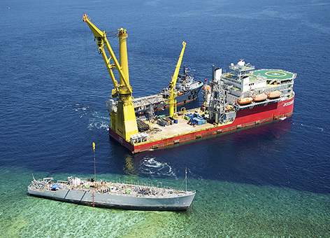 Salvage operations for grounded Navy mine ship Ex-Guardian on Philippines reef.