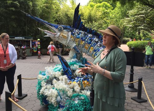 Angela Haseltine Pozzi instructing teachers next to a swordfish made of trash.