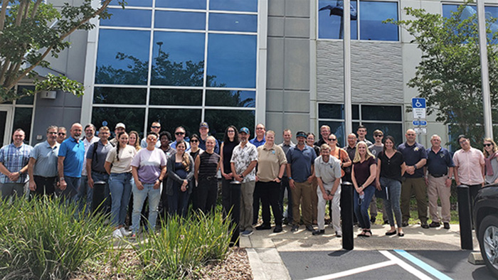 A group photo of 36 students from the SOCR Jacksonville class in front of a training facility. Photo credit: NOAA 