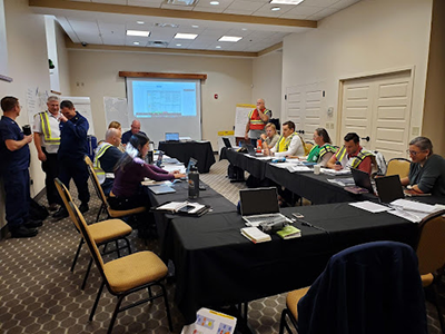 Several agencies and private industry participants around a table as part of the offshore wind spill exercise held October 2, 2023. Image credit: NOAA.