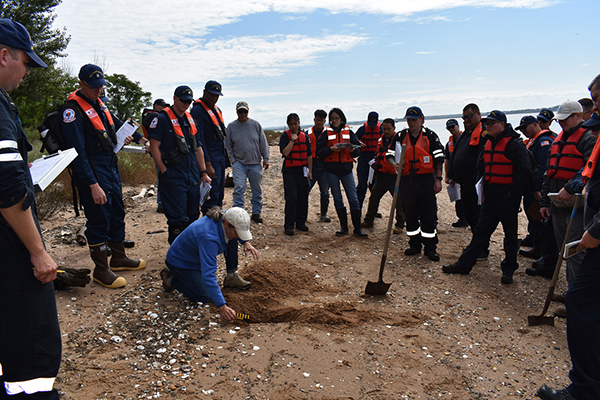 SCAT class participants observe the trainer measuring oil found in a trench. Image credit: NOAA/Frank Csulak.
