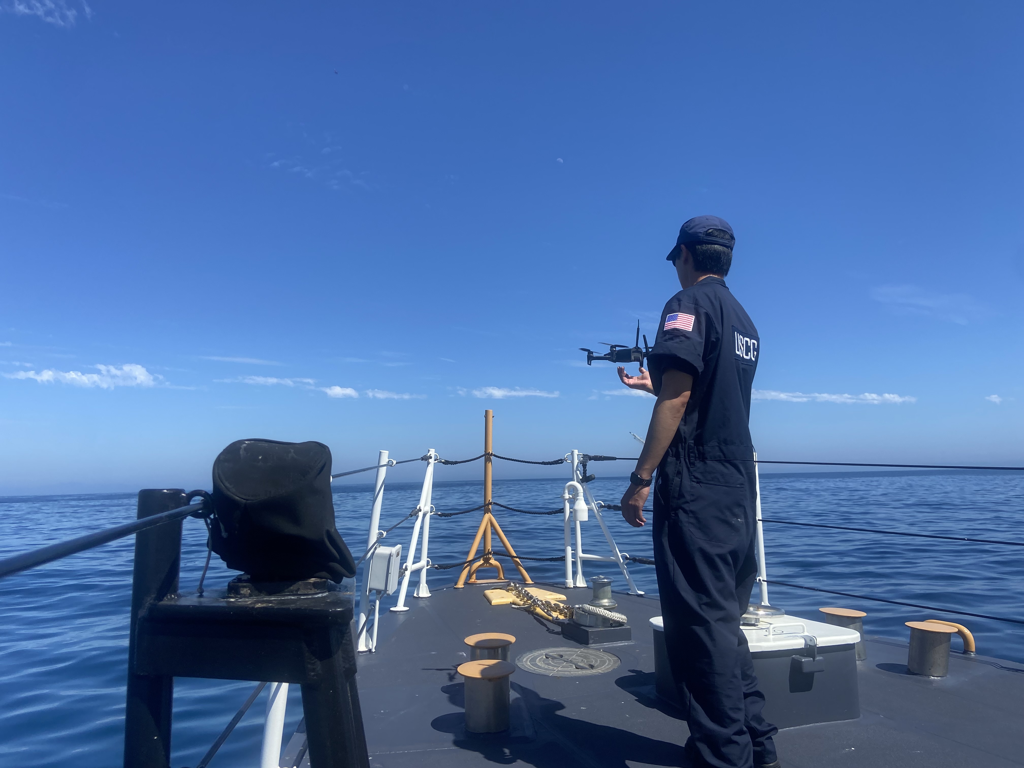 USCG UAS pilot, onboard the USCG Cutter Blackfin, completes a test flight by catching a drone after its flight over an oil slick off the Santa Barbara Coast. (Image Credit: NOAA). 