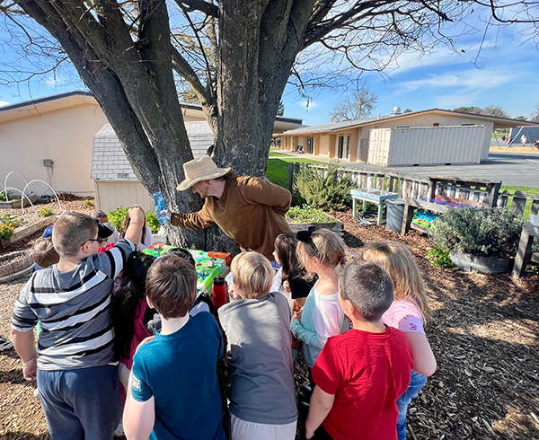 Students gathered around One Cool Earth Educator to learn about pollution in the local San Luis Obispo watershed and Morro Bay. 