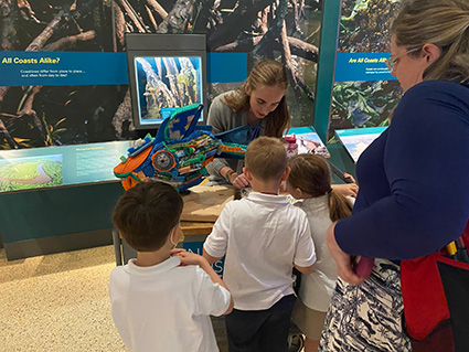 A NOAA Marine Debris Program Education Specialist shared tips for preventing marine debris, including turning it into art, with museum visitors of all ages (Credit: NOAA).