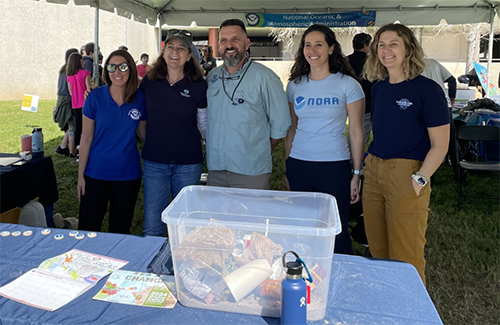 OR&R staff gathered at booth at the St. Petersburg Science Festival School Day.