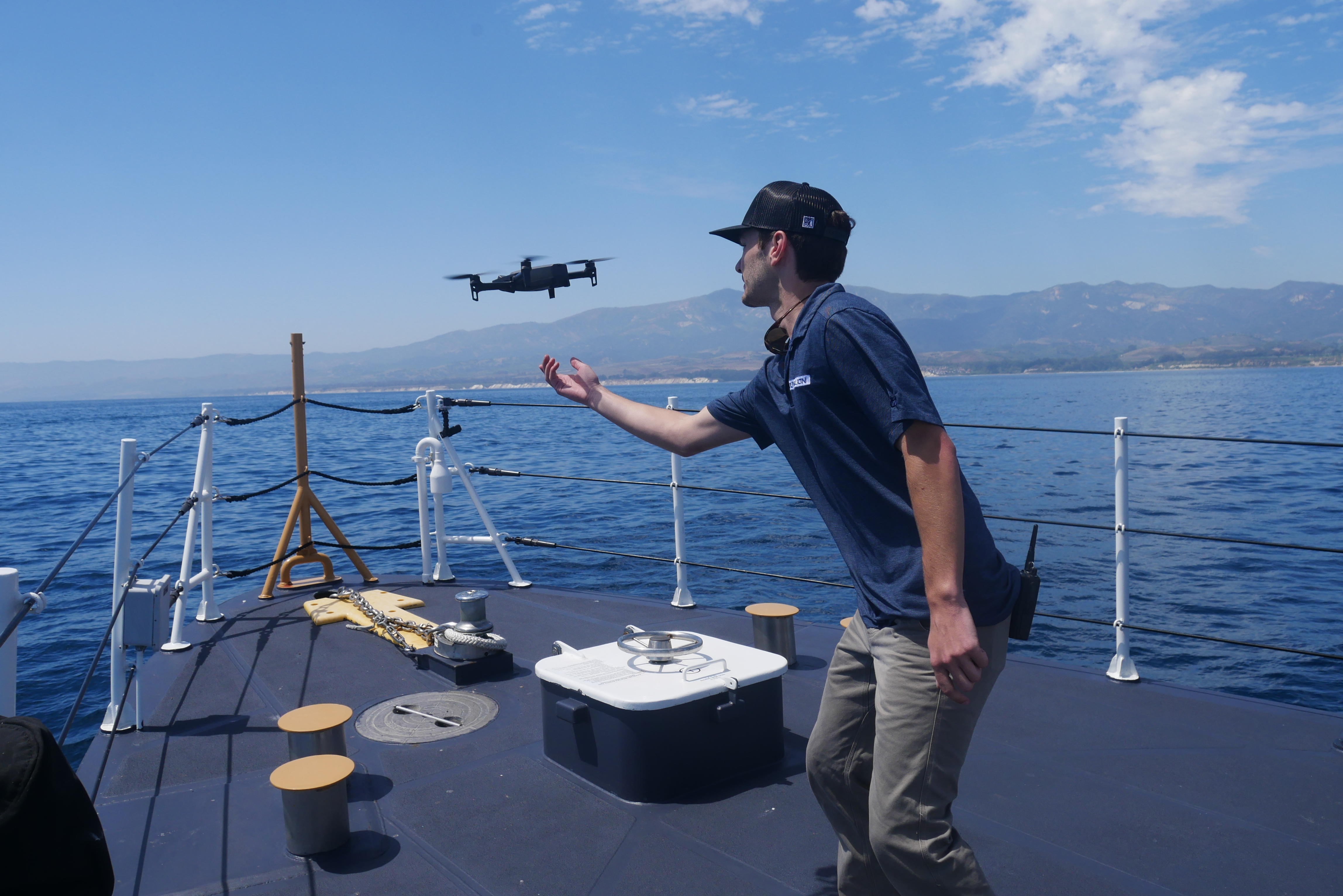 UAS pilot from the Couvillion Group prepared to catch a drone landing on the USCG Cutter Blackfin after its flight over an oil slick off the Santa Barbara Coast. (Image Credit: NOAA). 