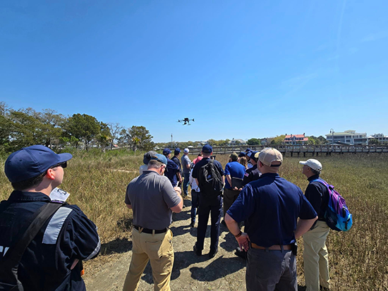 Students observing an uncrewed aircraft system taking flight as part of their training in Shoreline Cleanup Assessment Technique (SCAT). The training was hosted by U.S. Coast Guard Sector Charleston, South Carolina in March 2024. Image credit: USCG.