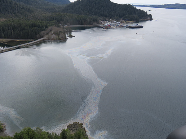 Oil sheen, containment boom, and deflection boom in Starrigavan Bay on April 23, 2017 (Photo provided by the US Coast Guard).