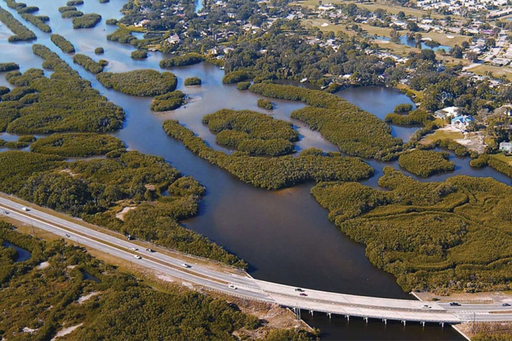 Aerial image of coastal community showing highway and estuary