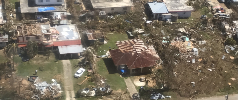 aerial image of debris and damaged houses following extreme weather event