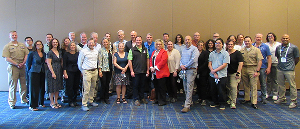 Group of NOAA scientists pose for a group photo at a conference.