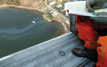 Responder in aircraft overlooking oil on water.