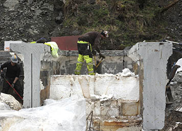Crews remove foam blocks from a cut-open section of the Japanese dock.