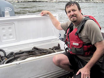 Tribal member displays cooler with harvest of lamprey.