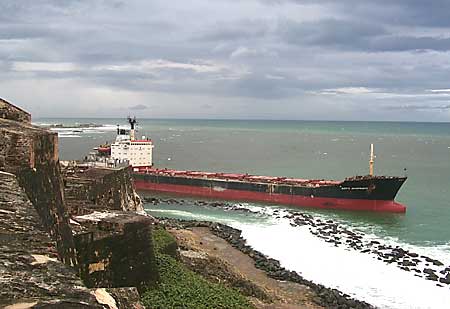 Photo: Freighter grounded in shallows just a few meters off the rocky shore.