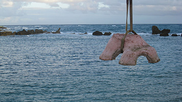 Lowering a prefabricated cement reef-replication modules into the ocean to create one of three underwater educational trails in Puerto Rico.