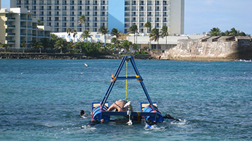 Transporting the premade cement reefs to set up the underwater educational coral reef trails in front of a public beach.