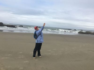 A woman holding up a piece of seagrass.