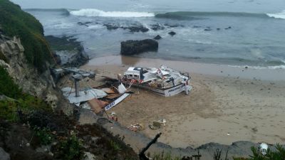 A broken up vessel on a beach. 