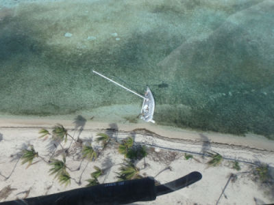 An aerial image of a grounded vessel on a beach.