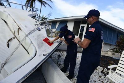 Woman placing a red tag on a vessel.