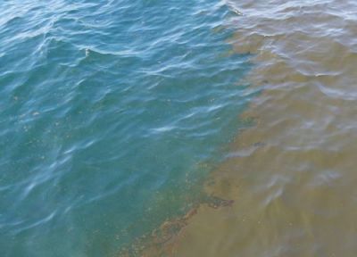 Edge of oil slick at ocean surface.