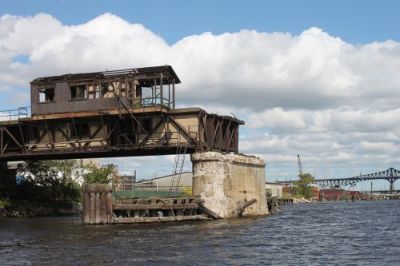 Ruins of an old railroad bridge end part way over the Passaic River.